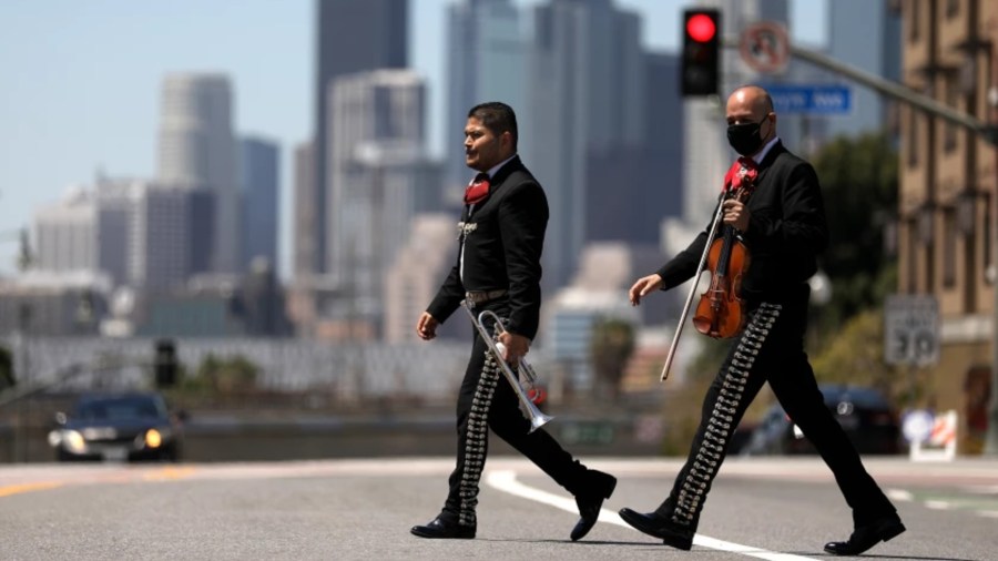 Mariachis cross 1st Street in Boyle Heights. In newly released U.S. census figures, the neighborhood recorded a decline in population, but downtown to the west saw a huge increase.(Gary Coronado / Los Angeles Times)