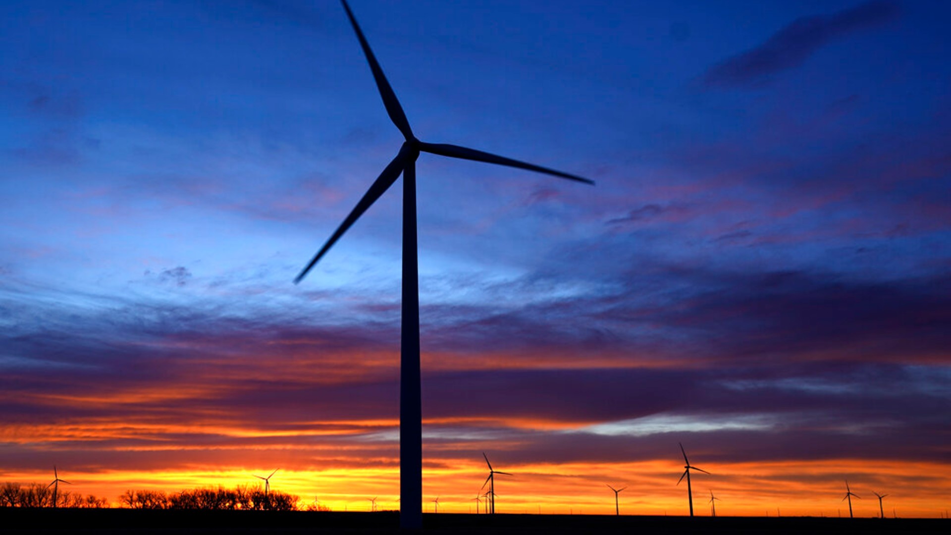 In this Jan. 13, 2021, file photo, wind turbines are silhouetted against the sky at dawn near Spearville, Kan. (AP Photo/Charlie Riedel, File)