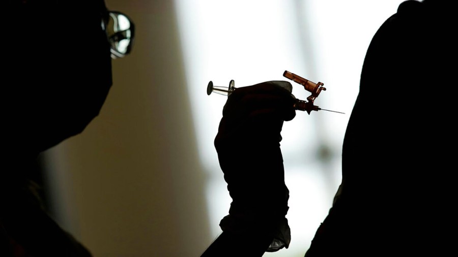 In this April 26, 2021, file photo, a nursing student administers the Moderna COVID-19 vaccine at a vaccination center at UNLV, in Las Vegas. (AP Photo/John Locher, File)