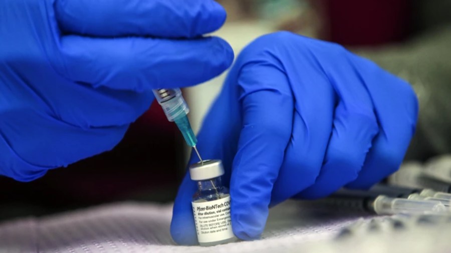 A Pfizer COVID-19 vaccine is prepared in May at a mobile vaccine clinic held at Franklin D. Roosevelt Park in Los Angeles.(Irfan Khan/Los Angeles Times)