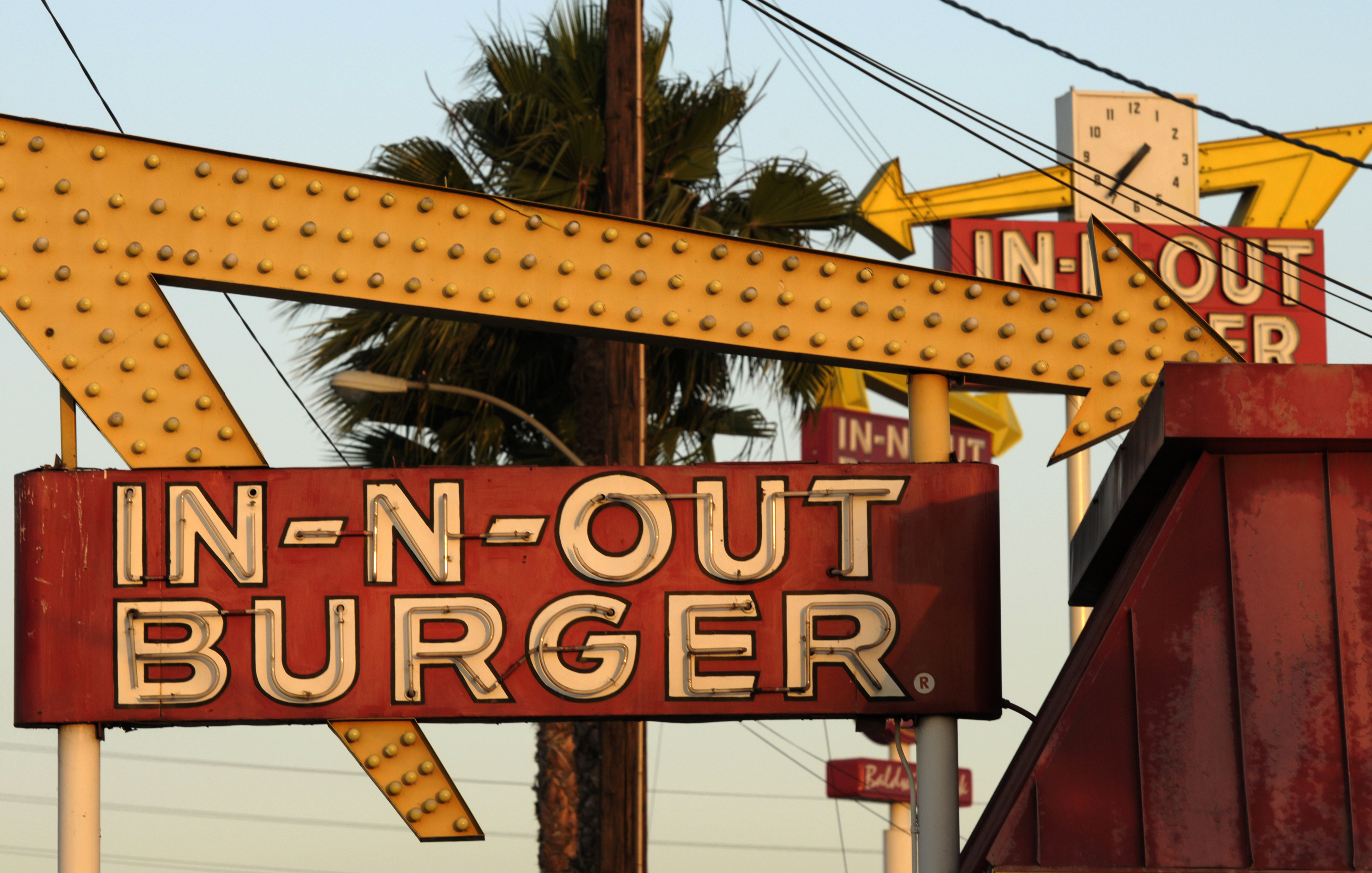 In this June 8, 2010, file photo, In-N-Out Burger signs fill the skyline in Baldwin Park. The restaurant's San Francisco was the location temporarily shut down. (AP Photo/Adam Lau, File)