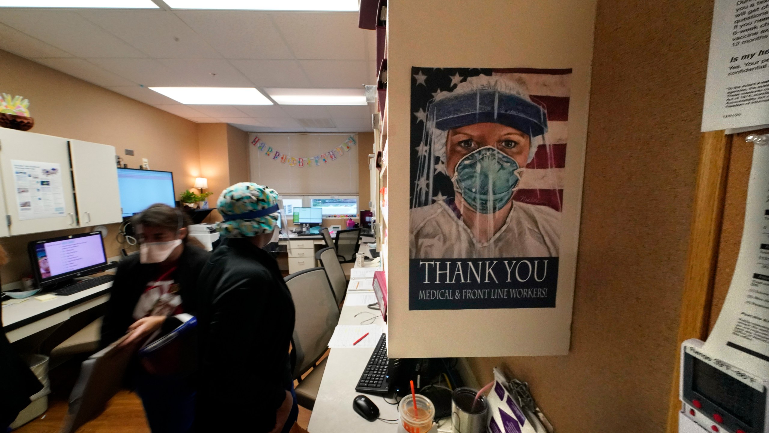 In this Aug. 18, 2021, file photo, a poster honoring medical and frontline workers, hangs on a nursing station of an intensive care unit, at the Willis-Knighton Medical Center in Shreveport, La. (AP Photo/Gerald Herbert, File)