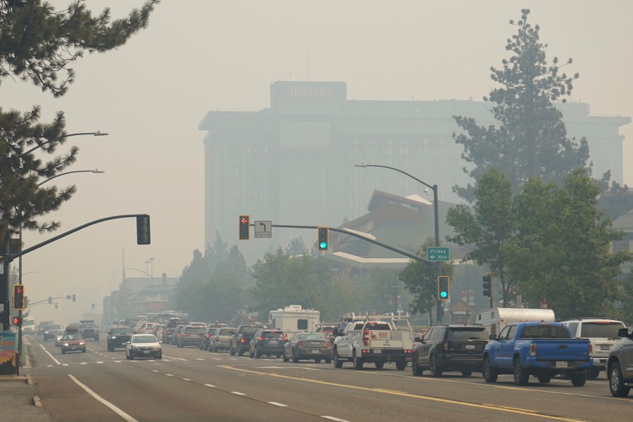 In this Aug. 30, 2021, file photo, vehicles idle in bumper-to-bumper traffic after a wildfire evacuation order in South Lake Tahoe, Calif. The threat the Caldor Fire poses to Lake Tahoe residents is exposing differences between laws against price-gouging in Nevada and California. Evacuees are reporting rideshare companies quoting trips from area ski resorts to the Reno-Tahoe International Airport at eight times the normal rate and hotels on the Nevada side of the resort town hiked room rates to $449 per night on Tuesday, Aug. 31, 2021. (AP Photo/Sam Metz, File)