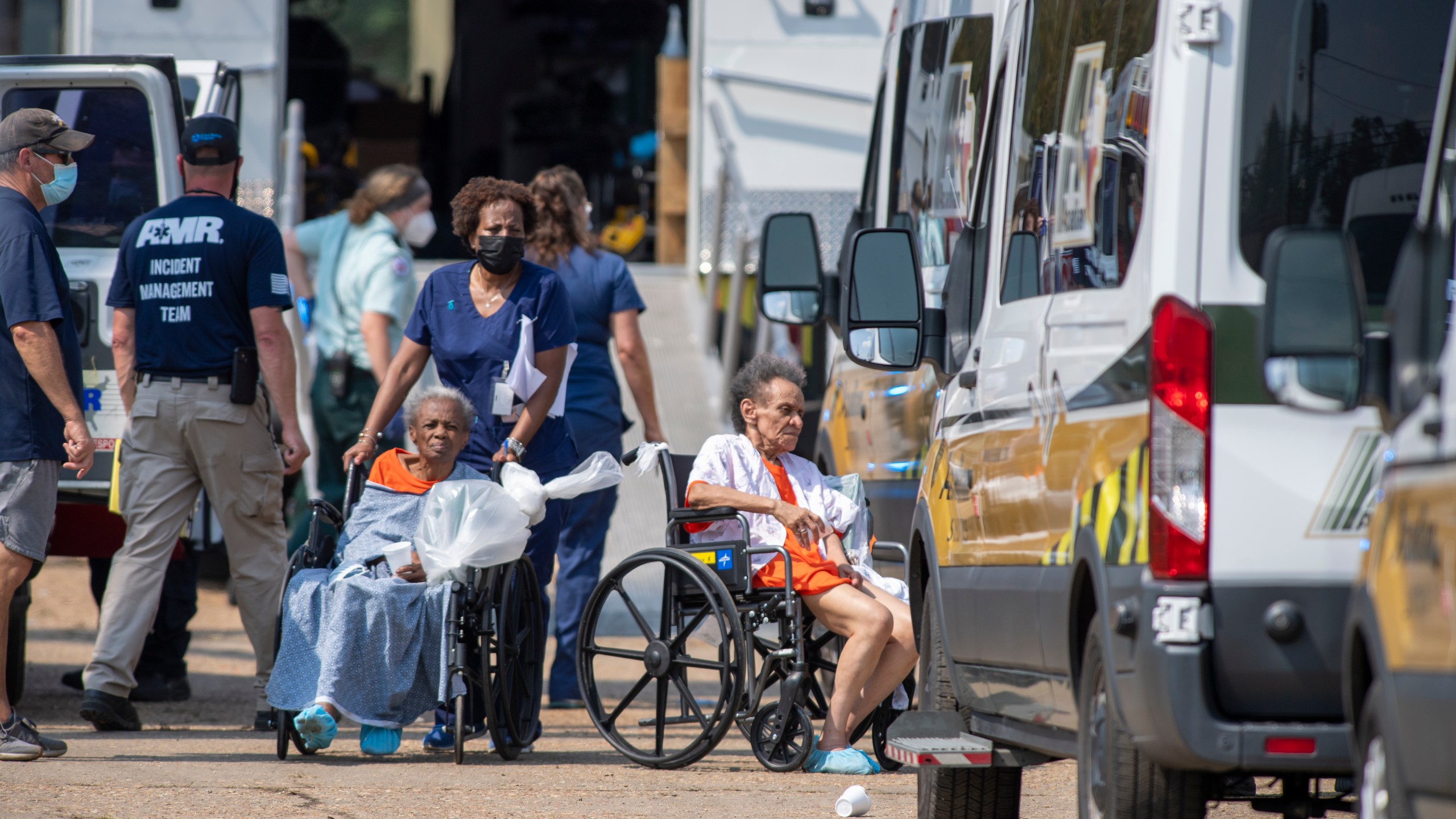 Paramedics evacuate people at a mass shelter Thursday, Sep.t 2, 2021 in Independence, La. Multiple nursing home residents died after Hurricane Ida, but full details of their deaths are unknown because state health inspectors said Thursday that they were turned away from examining conditions at the facility to which they had been evacuated. (Chris Granger/The Times-Picayune/The New Orleans Advocate via AP)