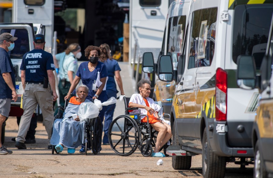 Paramedics evacuate people at a mass shelter Thursday, Sep.t 2, 2021 in Independence, La. Multiple nursing home residents died after Hurricane Ida, but full details of their deaths are unknown because state health inspectors said Thursday that they were turned away from examining conditions at the facility to which they had been evacuated. (Chris Granger/The Times-Picayune/The New Orleans Advocate via AP)