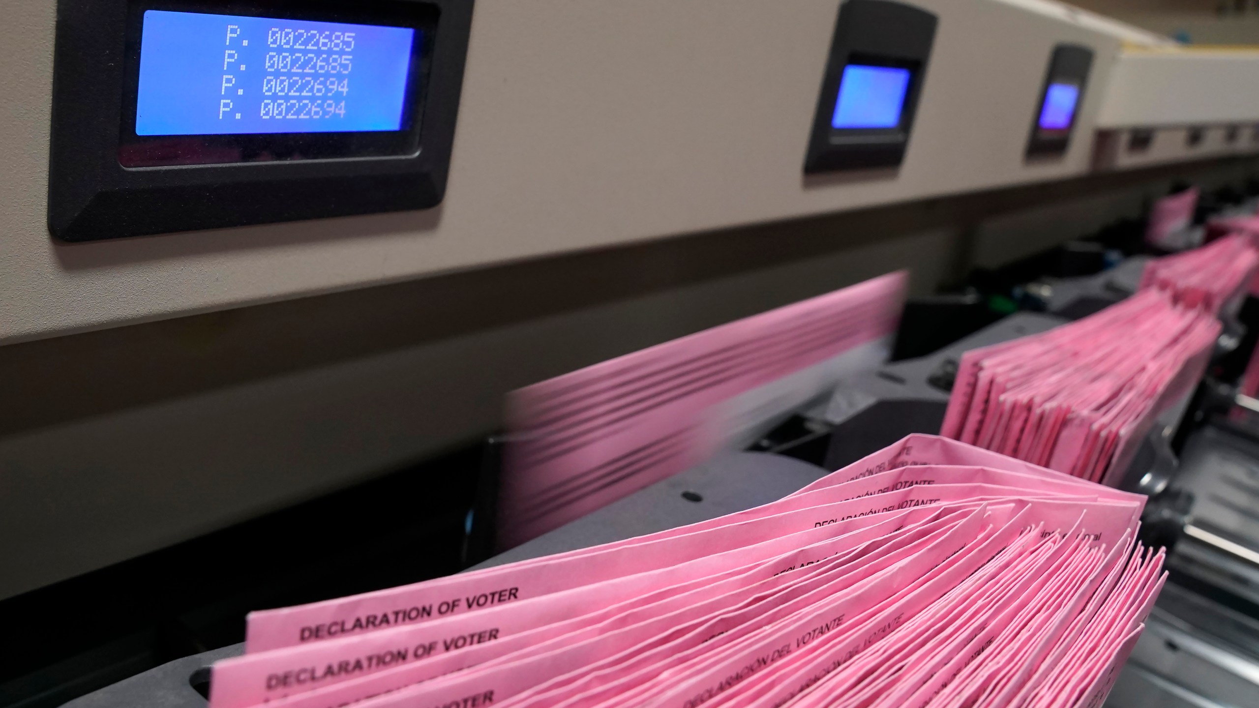 In this Aug. 30, 2021, file photo mail in ballots run through a sorting machine at the Sacramento County Registrar of Voters office in Sacramento, Calif. (AP Photo/Rich Pedroncelli, File)