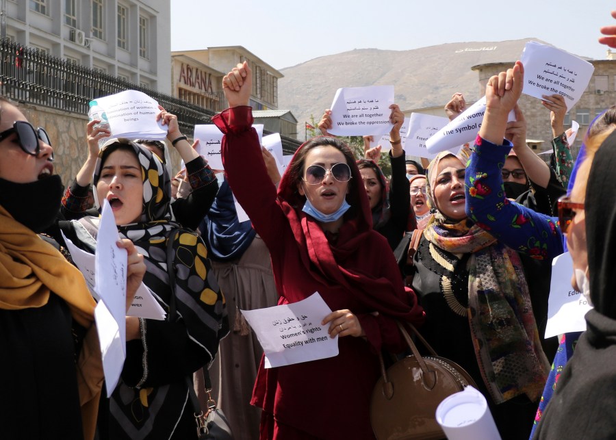 Women gather to demand their rights under the Taliban rule during a protest in Kabul, Afghanistan, Friday, Sept. 3, 2021. As the world watches intently for clues on how the Taliban will govern, their treatment of the media will be a key indicator, along with their policies toward women. When they ruled Afghanistan between 1996-2001, they enforced a harsh interpretation of Islam, barring girls and women from schools and public life, and brutally suppressing dissent. (AP Photo/Wali Sabawoon)