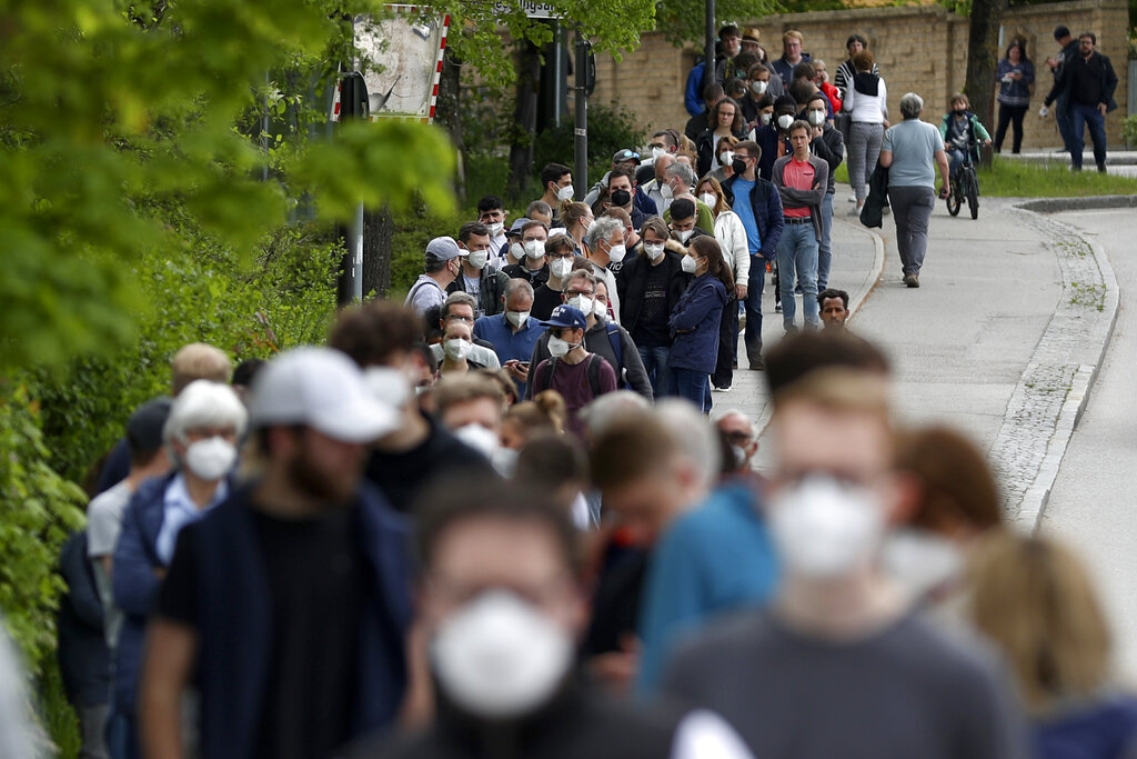 In this Saturday, May 15, 2021 file photo, people queue at a vaccination centre in Ebersberg near Munich, Germany. (AP Photo/Matthias Schrader, file)