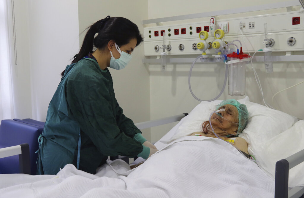 A nurse monitors Ayse Karatay at the City Hospital in Eskisehir, western Turkey, Saturday, Sept. 4, 2021. (IHA via AP)