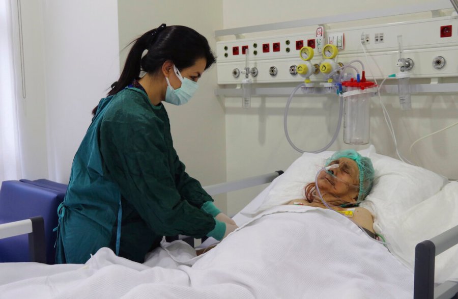 A nurse monitors Ayse Karatay at the City Hospital in Eskisehir, western Turkey, Saturday, Sept. 4, 2021. (IHA via AP)