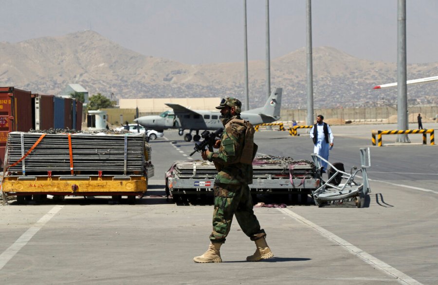 A Taliban soldier walks on the tarmac at Hamid Karzai International Airport in Kabul, Afghanistan, Sunday, Sept. 5, 2021. (AP Photo/Wali Sabawoon)