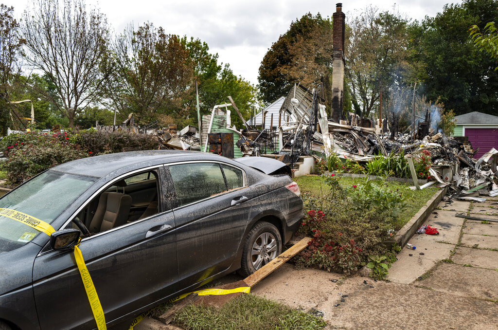 The remains of a home that burned still smolders in Manville, N.J., Sunday, Sept. 5, 2021, in the wake of the remnants of Hurricane Ida. (AP Photo/Craig Ruttle)