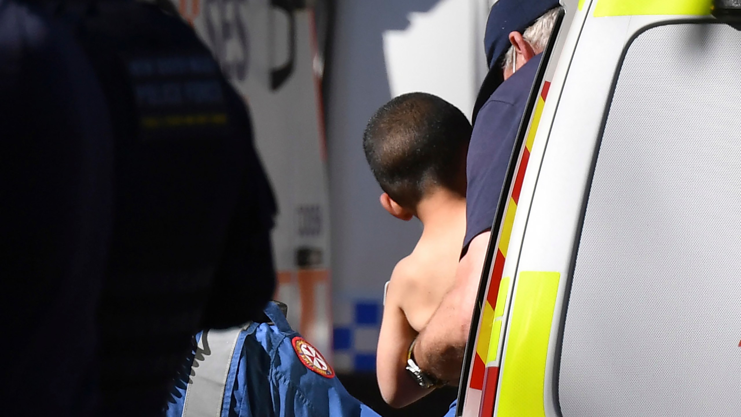 Three-year-old AJ Elfalak is carried by a paramedic into an ambulance after he is found alive on the family property near Putty, north west of Sydney, Australia, Monday, Sept. 6, 2021. AJ was found sitting in a creek and cupping water in his hands to drink three days after he was lost in rugged Australian woodland. (Dean Lewins/AAP Image via AP)