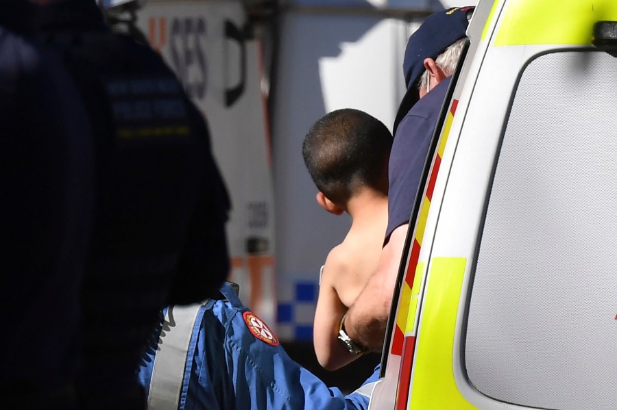 Three-year-old AJ Elfalak is carried by a paramedic into an ambulance after he is found alive on the family property near Putty, north west of Sydney, Australia, Monday, Sept. 6, 2021. AJ was found sitting in a creek and cupping water in his hands to drink three days after he was lost in rugged Australian woodland. (Dean Lewins/AAP Image via AP)