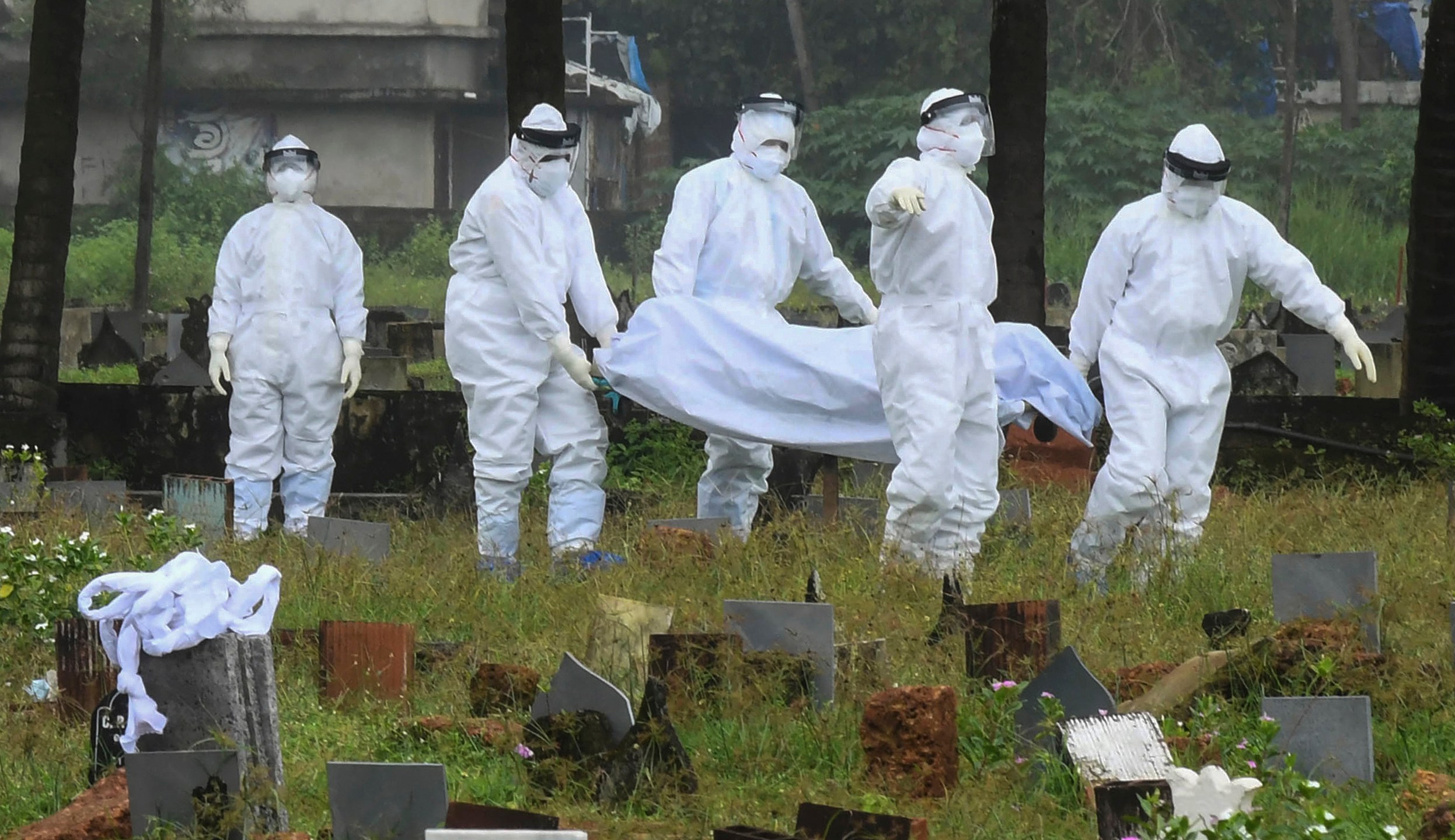 People in protective suits prepare to cremate the body of a 12-year-old boy died of the Nipah virus in Kozhikode, Kerala state, India, Sunday, Sept.5, 2021. The southern Indian state is quickly ramping up efforts to stop a potential outbreak of the deadly Nipah virus, even as it continues to battle the highest number of coronavirus cases in the country. (AP Photo/Shijith. K)