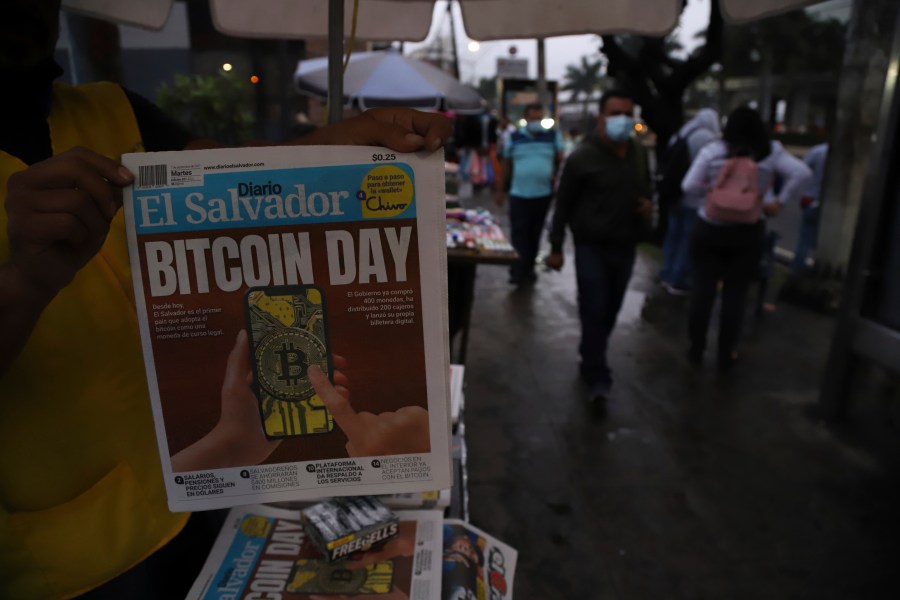 A newspaper vendor shows the front page of a state-run newspaper carrying the headline "Bitcoin Day" in San Salvador, El Salvador on Sept. 7, 2021. (Salvador Melendez/Associated Press)