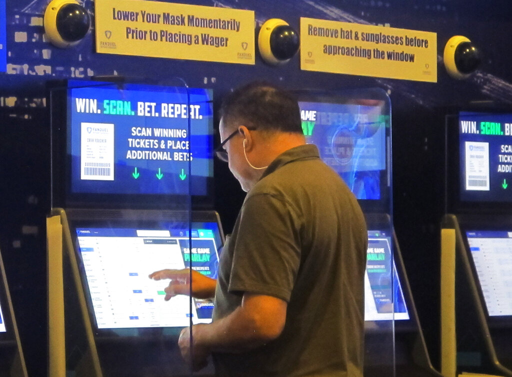 A gambler places a bet at the FanDuel sportsbook in East Rutherford N.J. on Aug. 30, 2021. (AP Photo/Wayne Parry)