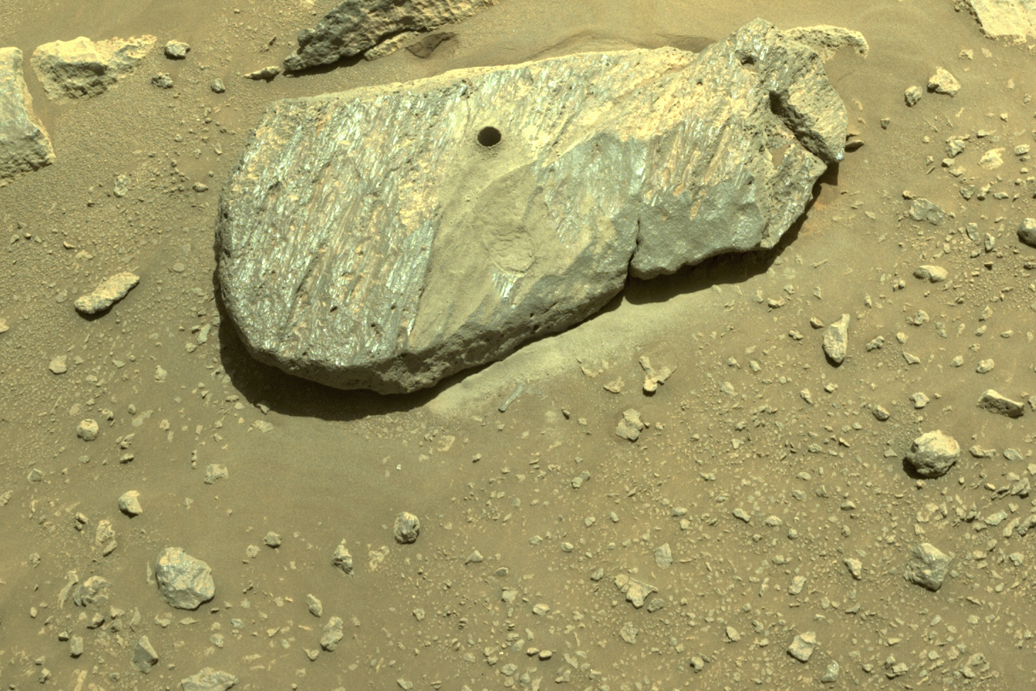 This Sept. 1, 2021 image provided by NASA shows the hole drilled by the Perseverance rover during its second sample-collection attempt in Mars' Jezero Crater. (NASA/JPL-Caltech via Associated Press)