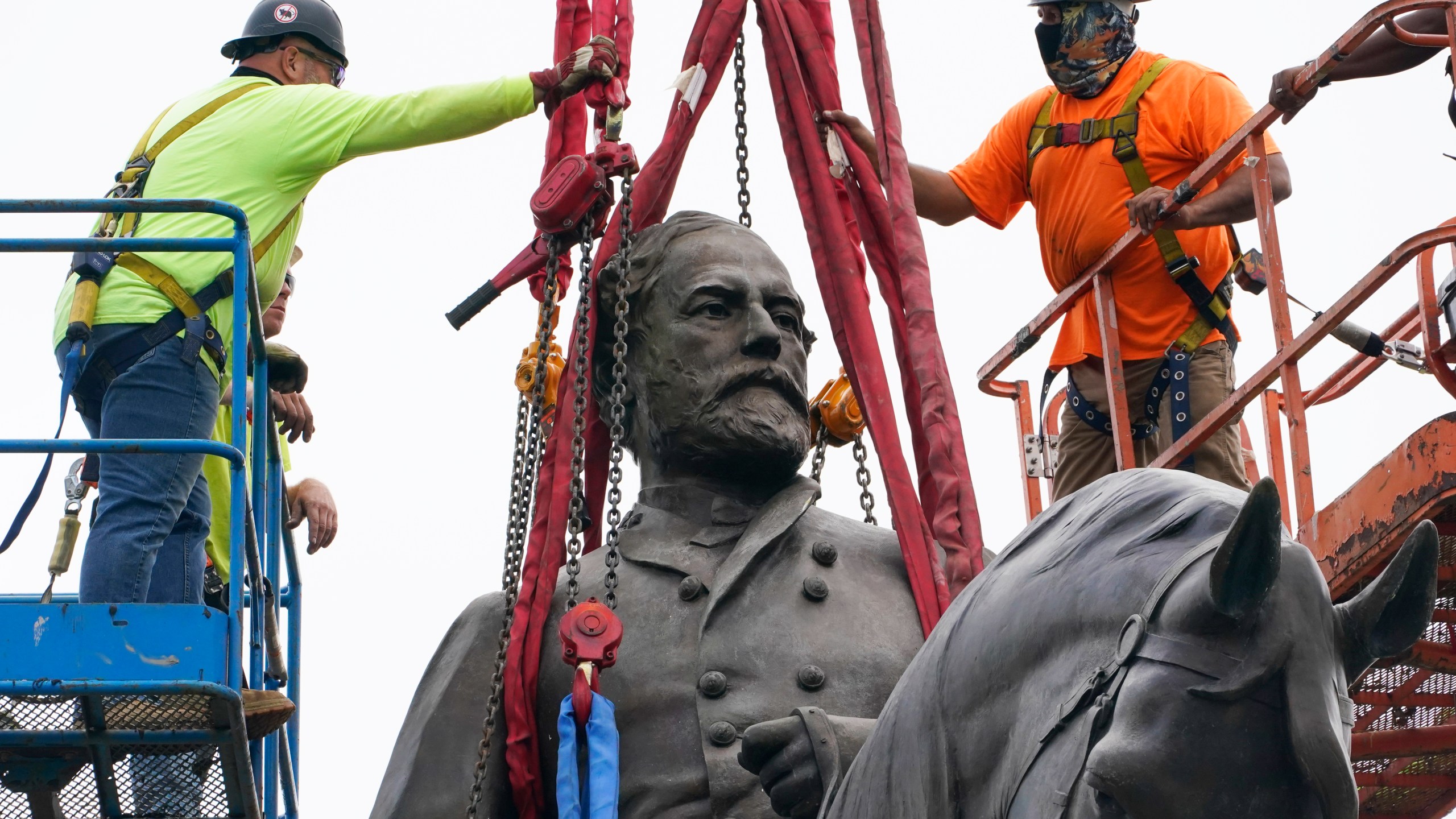 Crews work to remove one of the country's largest remaining monuments to the Confederacy, a towering statue of Confederate General Robert E. Lee on Monument Avenue, Wednesday, Sept. 8, 2021, in Richmond, Va. (AP Photo/Steve Helber, Pool)