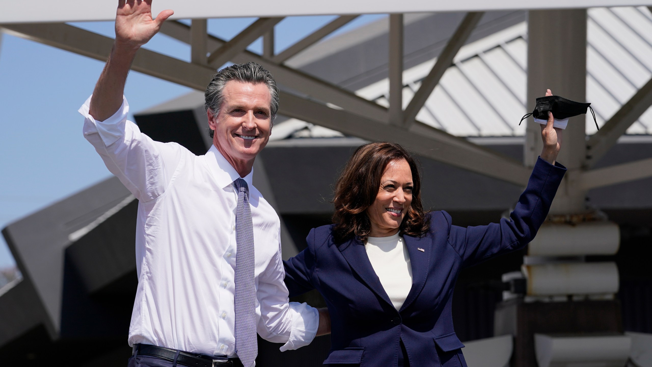 California Gov. Gavin Newsom and Vice President Kamala Harris wave during a campaign event at the IBEW-NECA Joint Apprenticeship Training Center in San Leandro, Calif. on Sept. 8, 2021. (AP Photo/Carolyn Kaster)