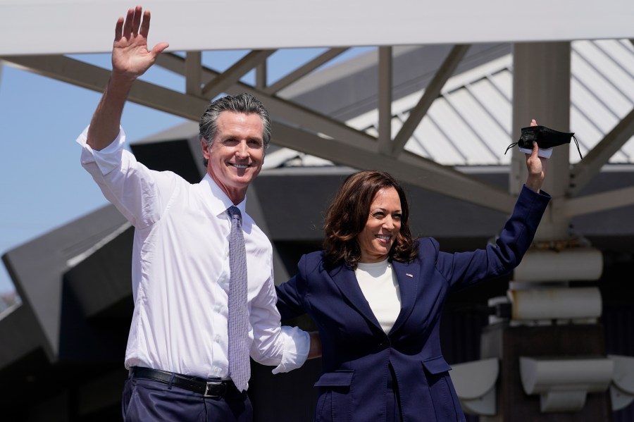 California Gov. Gavin Newsom and Vice President Kamala Harris wave during a campaign event at the IBEW-NECA Joint Apprenticeship Training Center in San Leandro, Calif. on Sept. 8, 2021. (AP Photo/Carolyn Kaster)