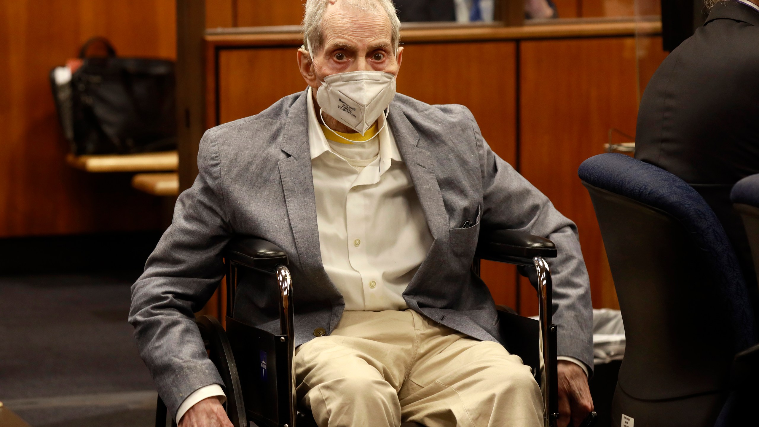 Robert Durst in his wheelchair spins in place as he looks at people in the courtroom in Inglewood, Calif. on Sept. 8, 2021, with his attorneys for closing arguments presented by the prosecution. (Al Seib/Los Angeles Times via AP, Pool)