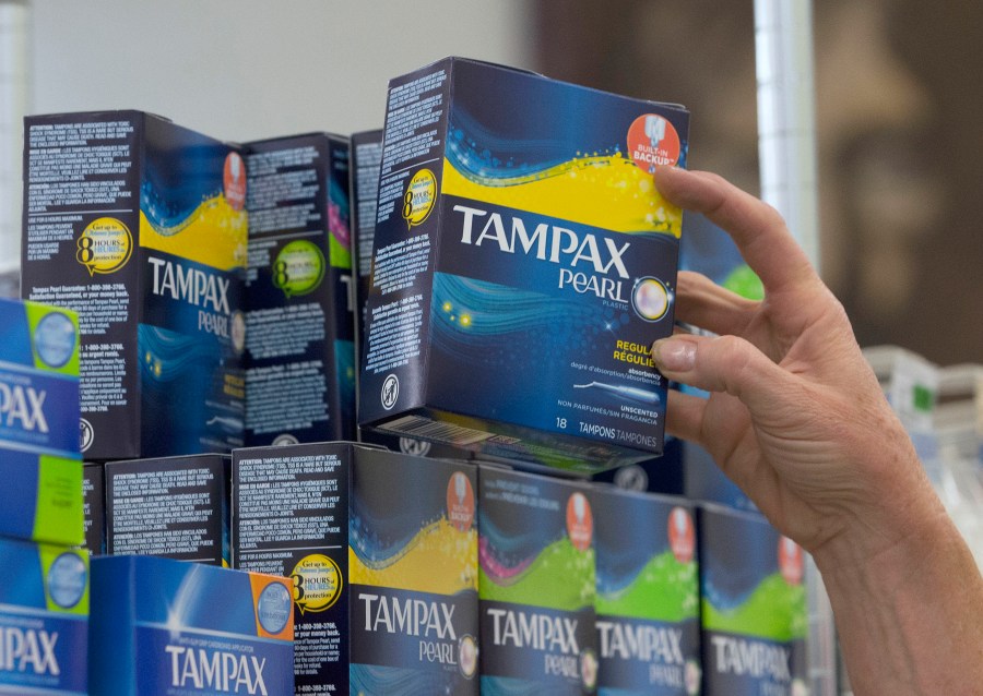 In this June 22, 2016, file photo, Tammy Compton restocks tampons at Compton's Market, in Sacramento, Calif. California public schools and colleges would have to stock their restrooms with free menstrual products under legislation sent to Gov. Gavin Newsom on Thursday, Sept. 9, 2021. The bill by Democratic Assemblywoman Cristina Garcia builds on her 2017 law requiring low-income schools in disadvantaged areas to provide students with free menstrual products. (AP Photo/Rich Pedroncelli, File)