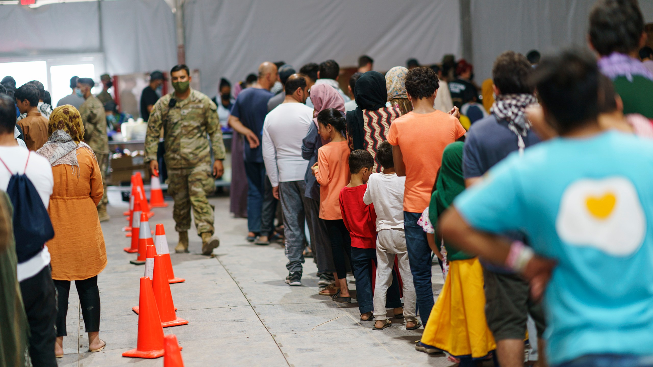 Afghan refugees line up for food in a dining hall at Fort Bliss' Doña Ana Village, in New Mexico, where they are being housed, on Sept. 10, 2021. (David Goldman / Associated Press)