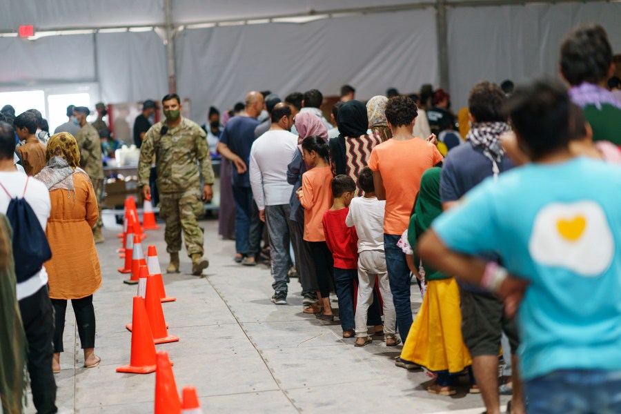 Afghan refugees line up for food in a dining hall at Fort Bliss' Doña Ana Village, in New Mexico, where they are being housed, on Sept. 10, 2021. (David Goldman / Associated Press)