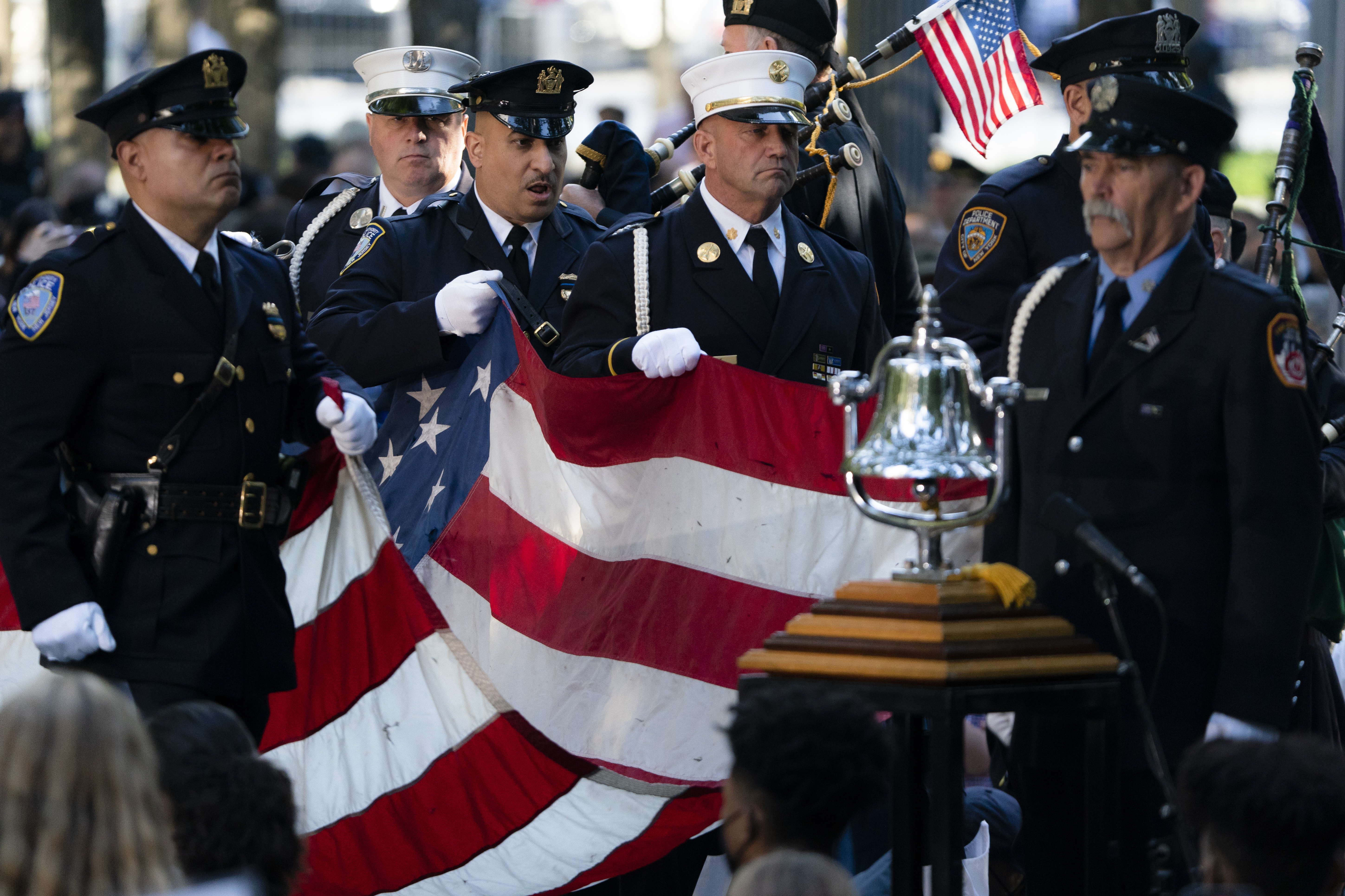 A memorial flag is brought onto the stage during ceremonies to commemorate the 20th anniversary of the Sept. 11 terrorist attacks, Saturday, Sept. 11, 2021, at the National September 11 Memorial & Museum in New York. (AP Photo/John Minchillo)