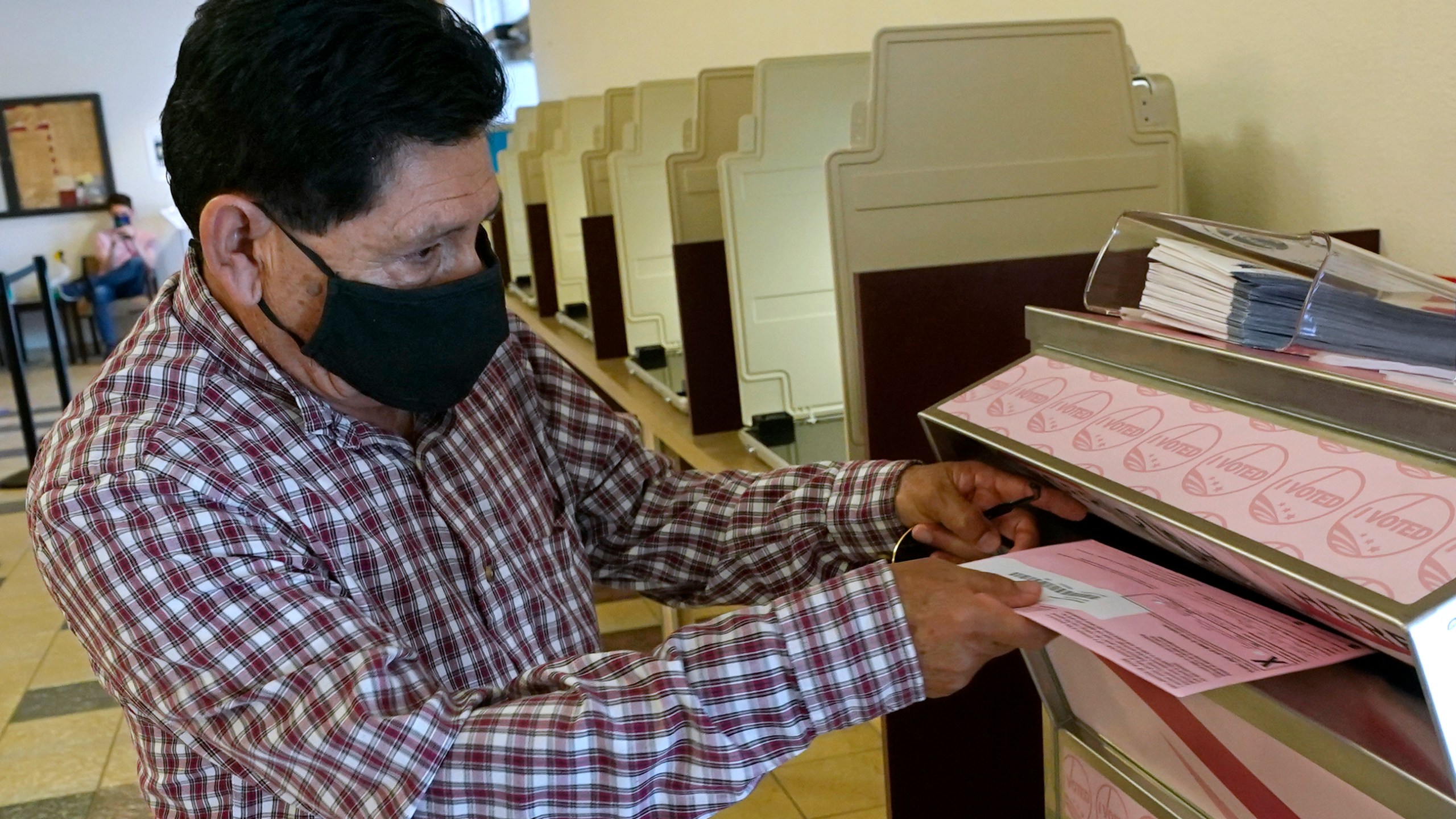 In this Aug. 30, 2021 file photo, Francisco Torres casts his ballot at the Sacramento County Registrar of Voters office in Sacramento, Calif. (AP Photo/Rich Pedroncelli, File)