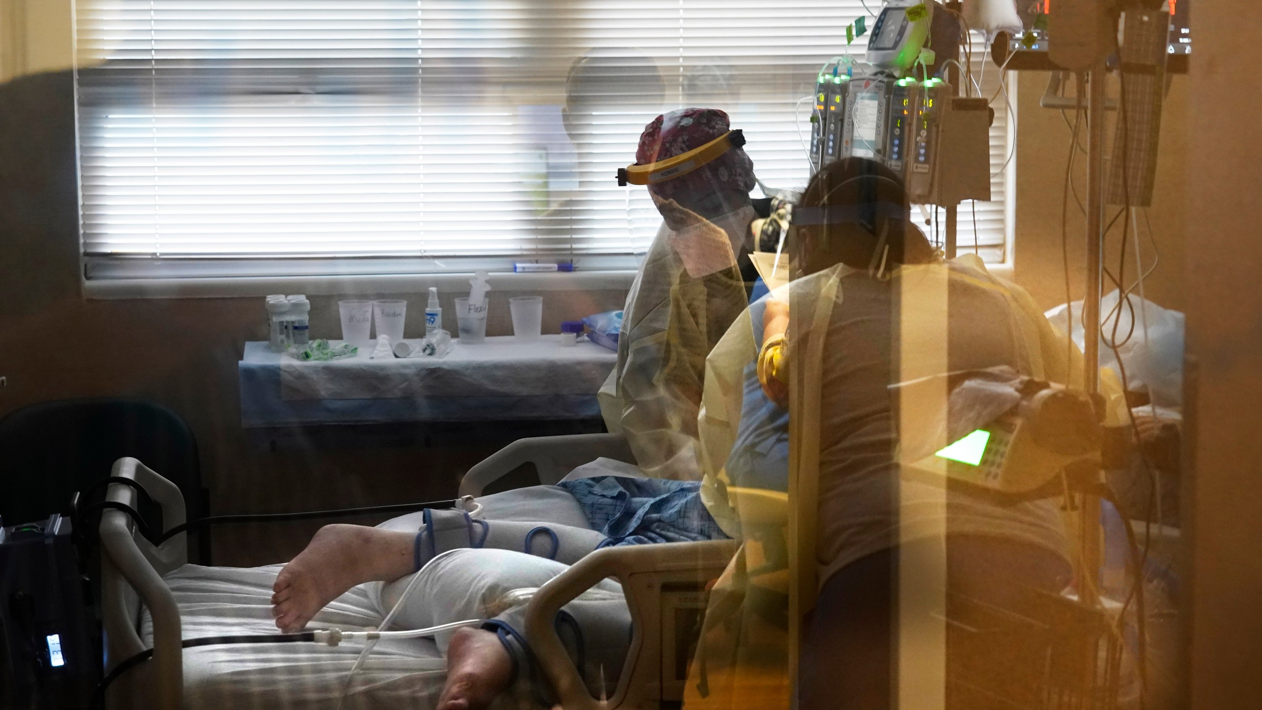 In this Aug. 18, 2021, file photo, medical staff tend to a patient with coronavirus, on a COVID-19 ward inside the Willis-Knighton Medical Center in Shreveport, La. (AP Photo/Gerald Herbert, File)