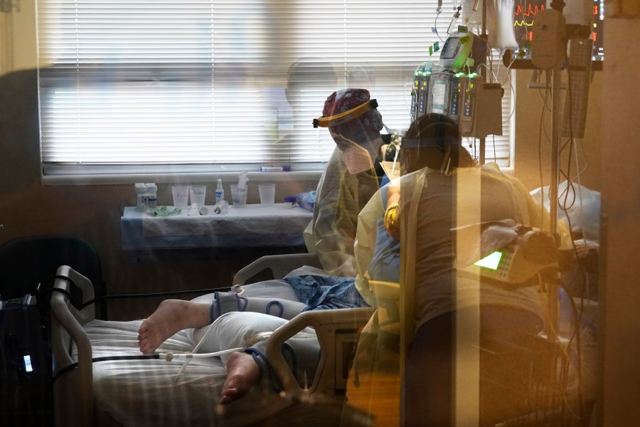 In this Aug. 18, 2021, file photo, medical staff tend to a patient with coronavirus, on a COVID-19 ward inside the Willis-Knighton Medical Center in Shreveport, La. (AP Photo/Gerald Herbert, File)