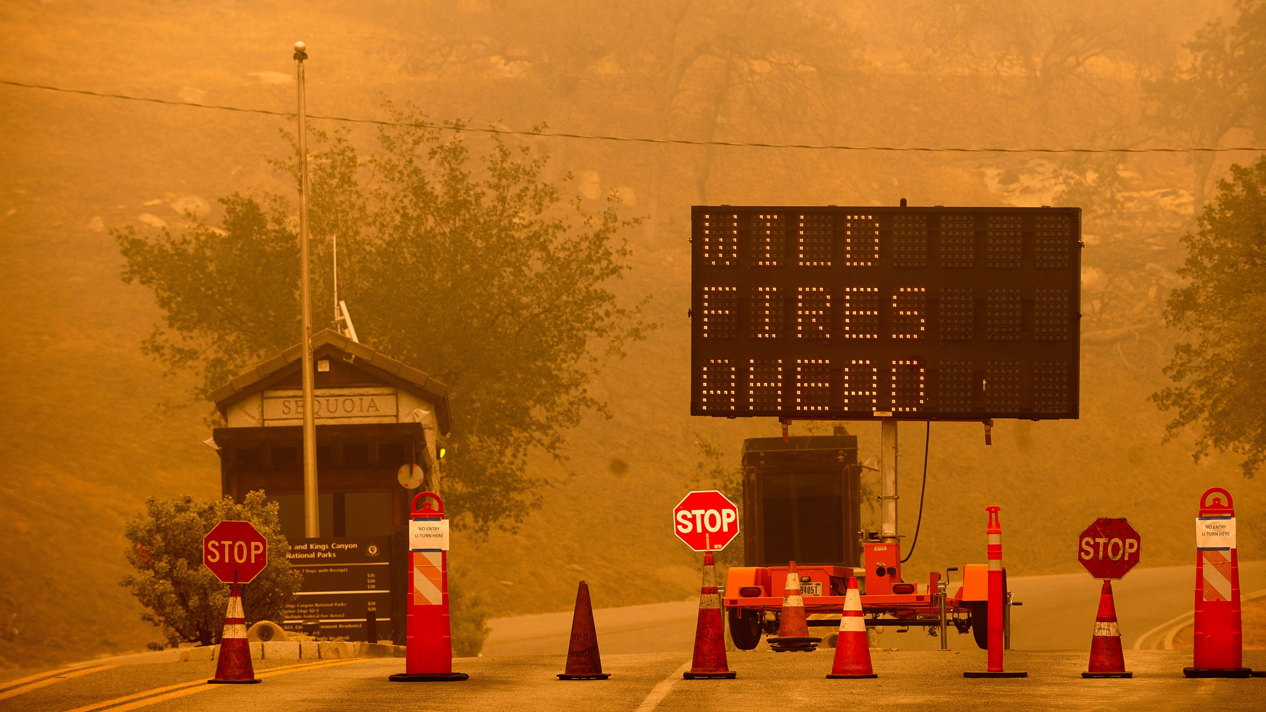 Cones block the entrance to Sequoia National Park as the KNP Complex Fire burns nearby on Sept. 15, 2021. (Noah Berger / Associated Press)