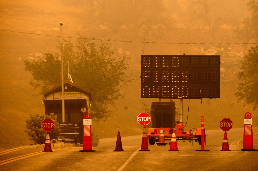 Cones block the entrance to Sequoia National Park as the KNP Complex Fire burns nearby on Sept. 15, 2021. (Noah Berger / Associated Press)