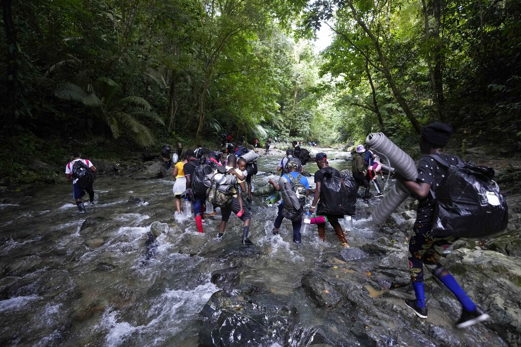 Migrants cross the Acandi River on their journey north, near Acandi, Colombia, Wednesday, Sept. 15, 2021. (AP Photo/Fernando Vergara)