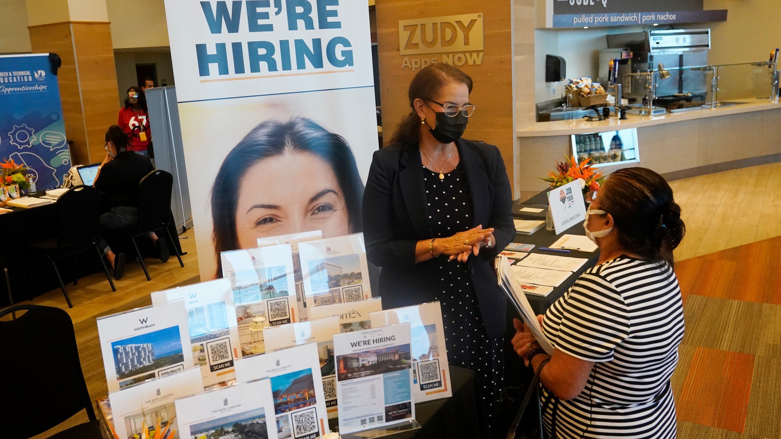 Marriott human resources recruiter Mariela Cuevas, left, talks to Lisbet Oliveros, during a job fair at Hard Rock Stadium on Sept. 3, 2021, in Miami Gardens, Fla. (AP Photo/Marta Lavandier)