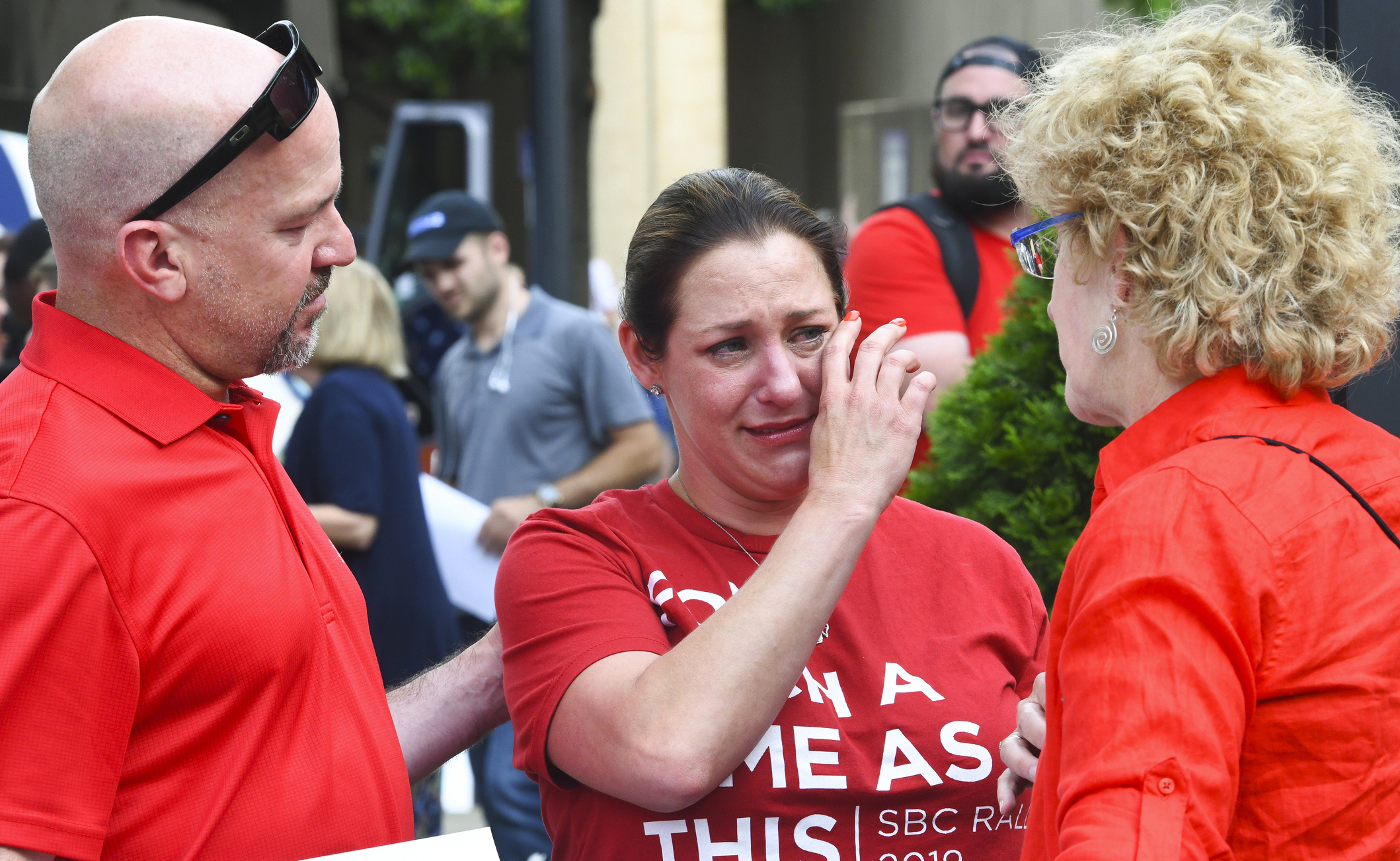 In this Tuesday, June 11, 2019 file photo, Jules Woodson, center, of Colorado Springs, Colo., is comforted by her boyfriend Ben Smith, left, and Christa Brown while demonstrating outside the Southern Baptist Convention's annual meeting in Birmingham, Ala. (AP Photo/Julie Bennett, File)