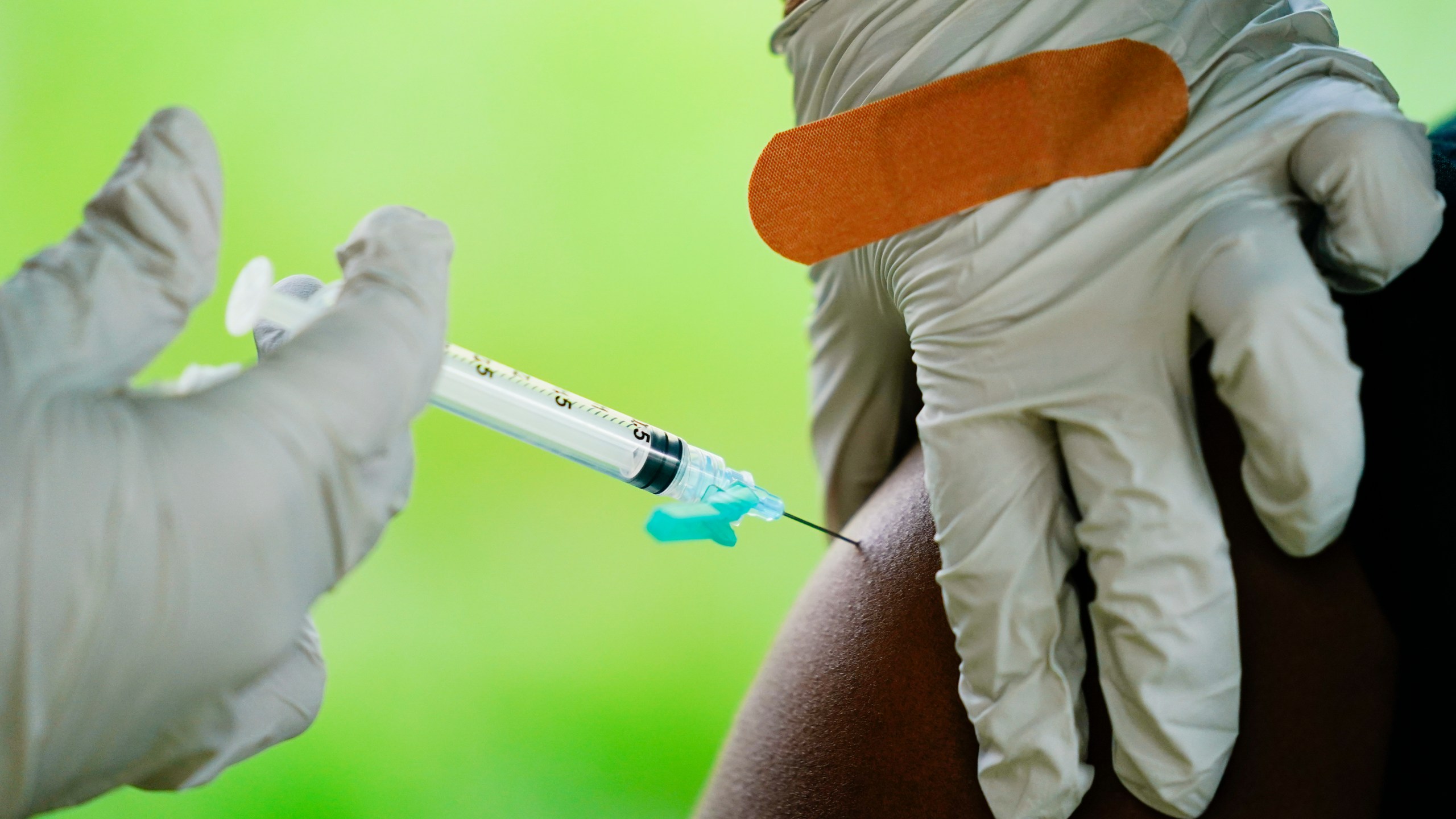 In this Sept. 14, 2021, file photo, a health worker administers a dose of a Pfizer COVID-19 vaccine during a vaccination clinic at the Reading Area Community College in Reading, Pa. (AP Photo/Matt Rourke, File)