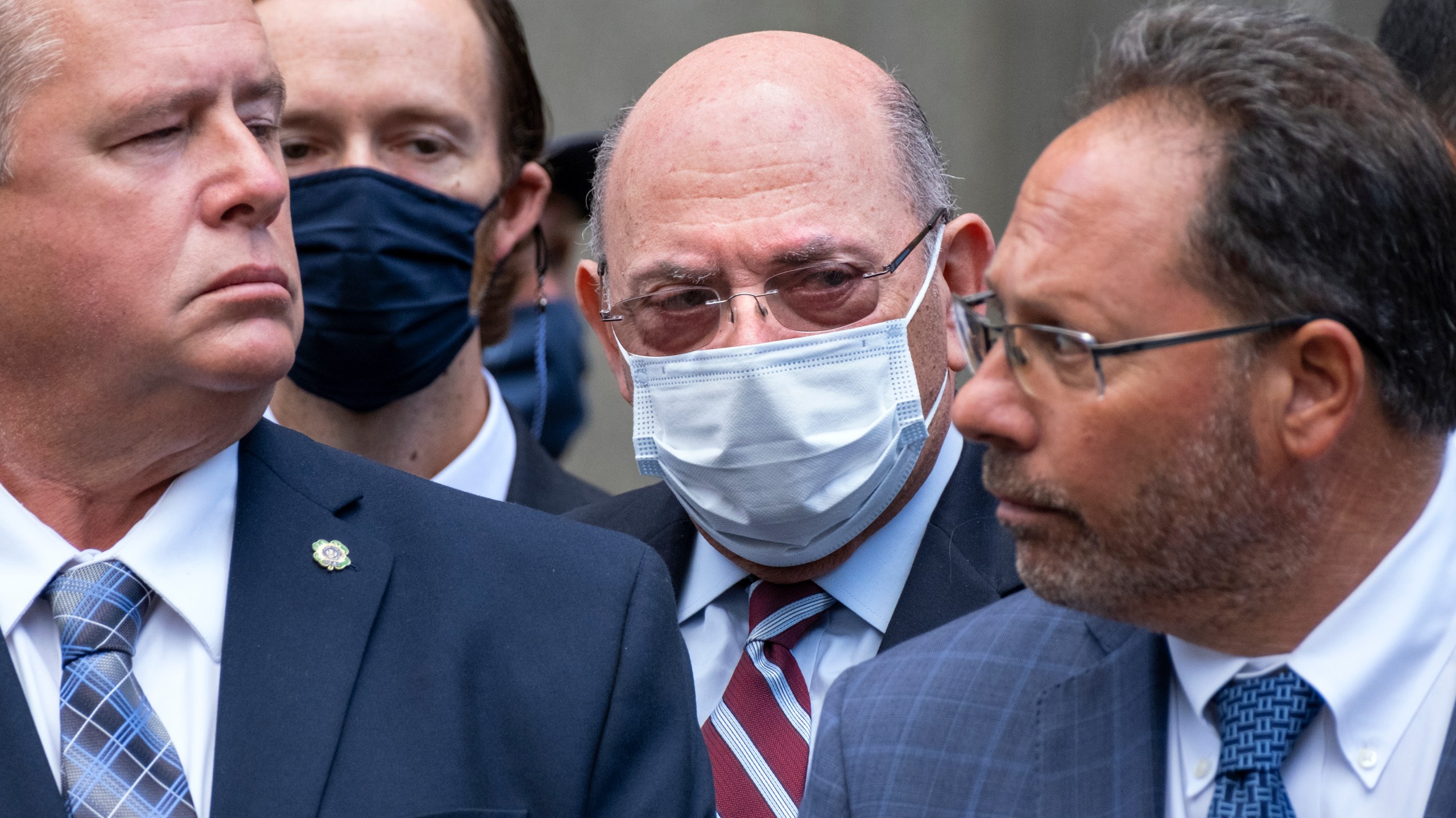 The Trump Organization's Chief Financial Officer Allen Weisselberg, center, awaits a car after leaving a courtroom appearance in New York, Monday, Sept. 20, 2021. Donald Trump's company and its longtime finance chief were charged Thursday in what a prosecutor called a "sweeping and audacious" tax fraud scheme that saw the Trump executive allegedly receive more than $1.7 million in off-the-books compensation, including apartment rent, car payments and school tuition. (AP Photo/Craig Ruttle)