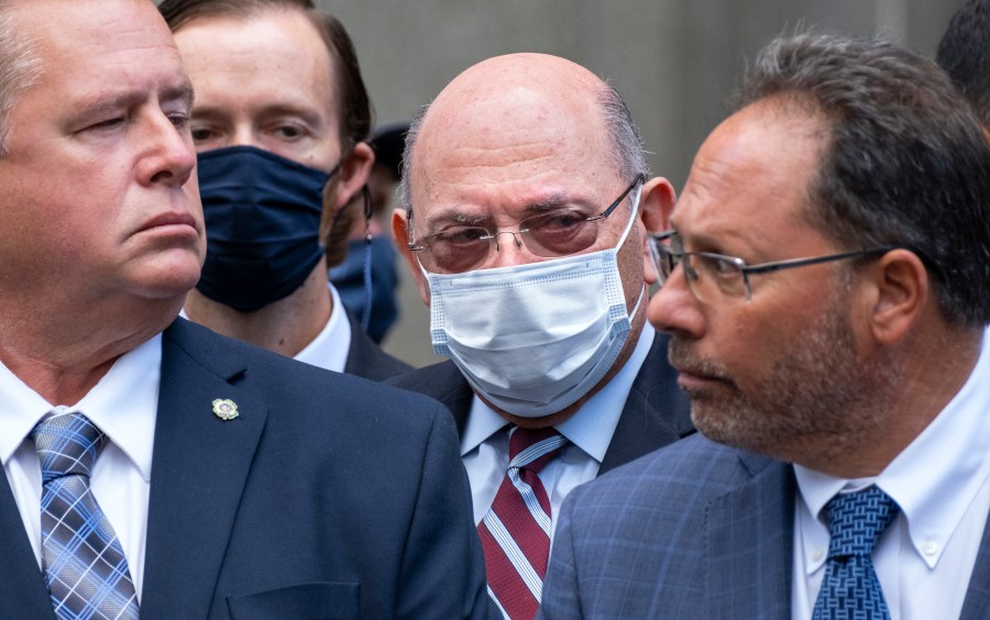 The Trump Organization's Chief Financial Officer Allen Weisselberg, center, awaits a car after leaving a courtroom appearance in New York, Monday, Sept. 20, 2021. Donald Trump's company and its longtime finance chief were charged Thursday in what a prosecutor called a "sweeping and audacious" tax fraud scheme that saw the Trump executive allegedly receive more than $1.7 million in off-the-books compensation, including apartment rent, car payments and school tuition. (AP Photo/Craig Ruttle)