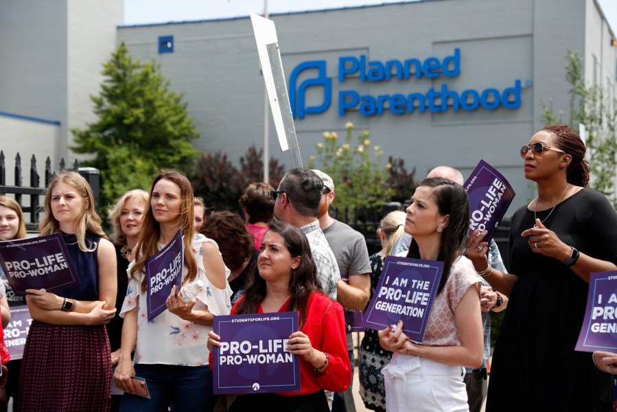 In this June 4, 2019, file photo, anti-abortion advocates gather outside the Planned Parenthood clinic in St. Louis. A federal appeals court on Tuesday, Sept. 21, 2021, will consider whether Missouri can implement a sweeping law aimed at limiting abortions. The law adopted in 2019 would ban abortions at or around the eighth week of pregnancy. It also would prohibit abortions based on a Down syndrome diagnosis. (AP Photo/Jeff Roberson, File)