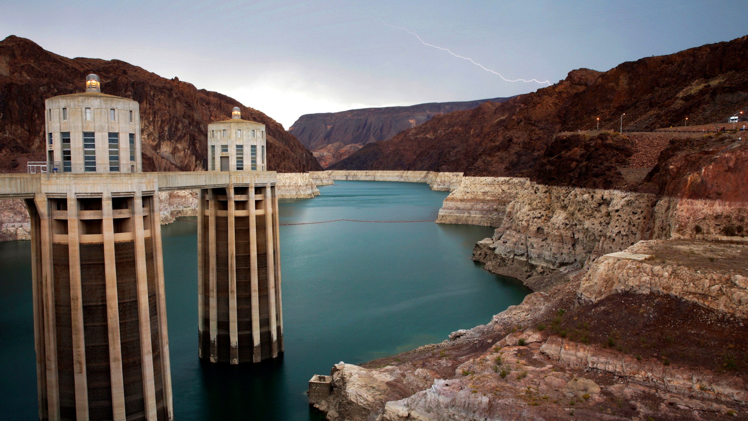 In this July 28, 2014, file photo, lightning strikes over Lake Mead near Hoover Dam that impounds Colorado River water at the Lake Mead National Recreation Area in Arizona. (AP Photo/John Locher, File)