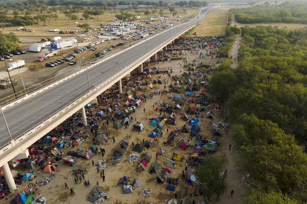 Migrants, many from Haiti, are seen at an encampment along the Del Rio International Bridge near the Rio Grande, Tuesday, Sept. 21, 2021, in Del Rio, Texas. (AP Photo/Julio Cortez)