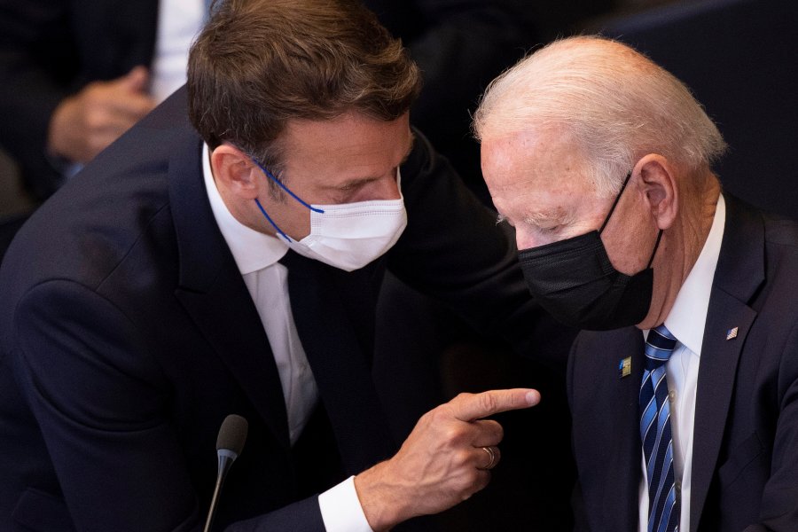 In this June 14, 2021 file photo, U.S. President Joe Biden, right, speaks with French President Emmanuel Macron during a plenary session during a NATO summit at NATO headquarters in Brussels. French President Emmanuel Macron expects "clarifications and clear commitments" from President Joe Biden in a call to be held later on Wednesday to address the submarines' dispute, Macron's office said. (Brendan Smialowski, Pool via AP, File)