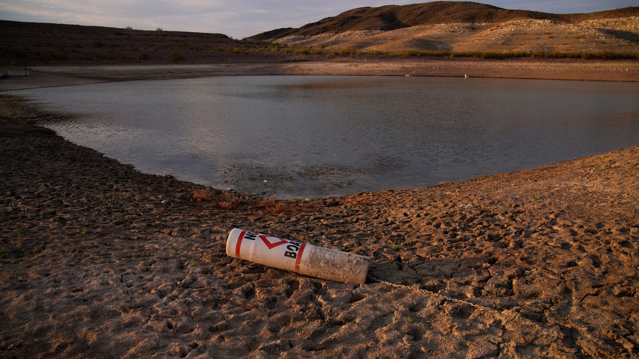 A buoy rests on the ground at a closed boat ramp on Lake Mead at the Lake Mead National Recreation Area near Boulder City, Nev., on Aug. 13, 2021. (John Locher / Associated Press)