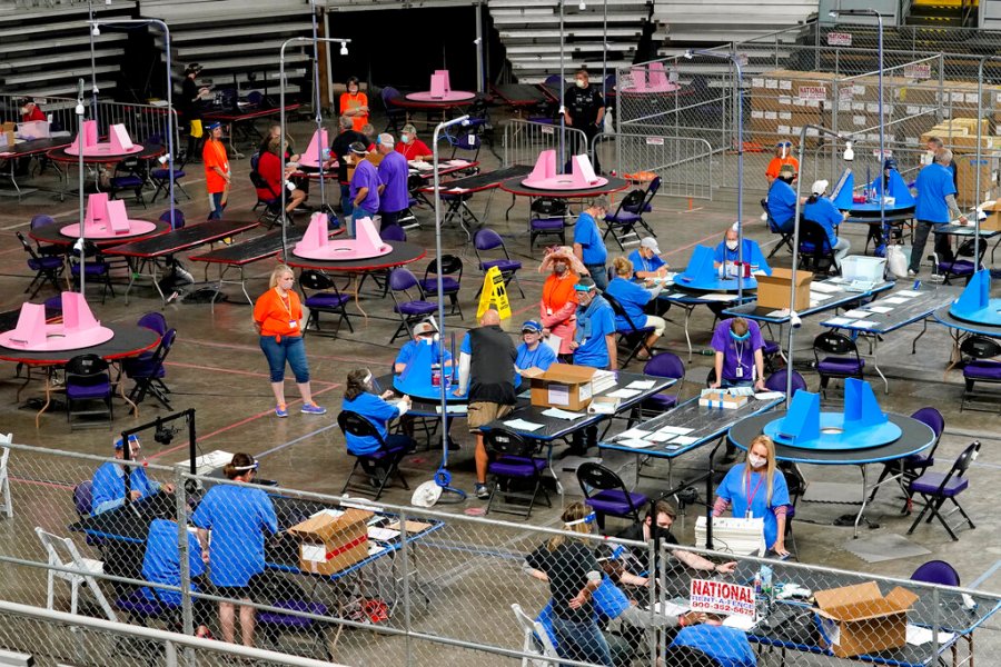 In this May 6, 2021, file photo, Maricopa County ballots cast in the 2020 general election are examined and recounted by contractors working for Florida-based company, Cyber Ninjas at Veterans Memorial Coliseum in Phoenix. (AP Photo/Matt York, Pool, File)