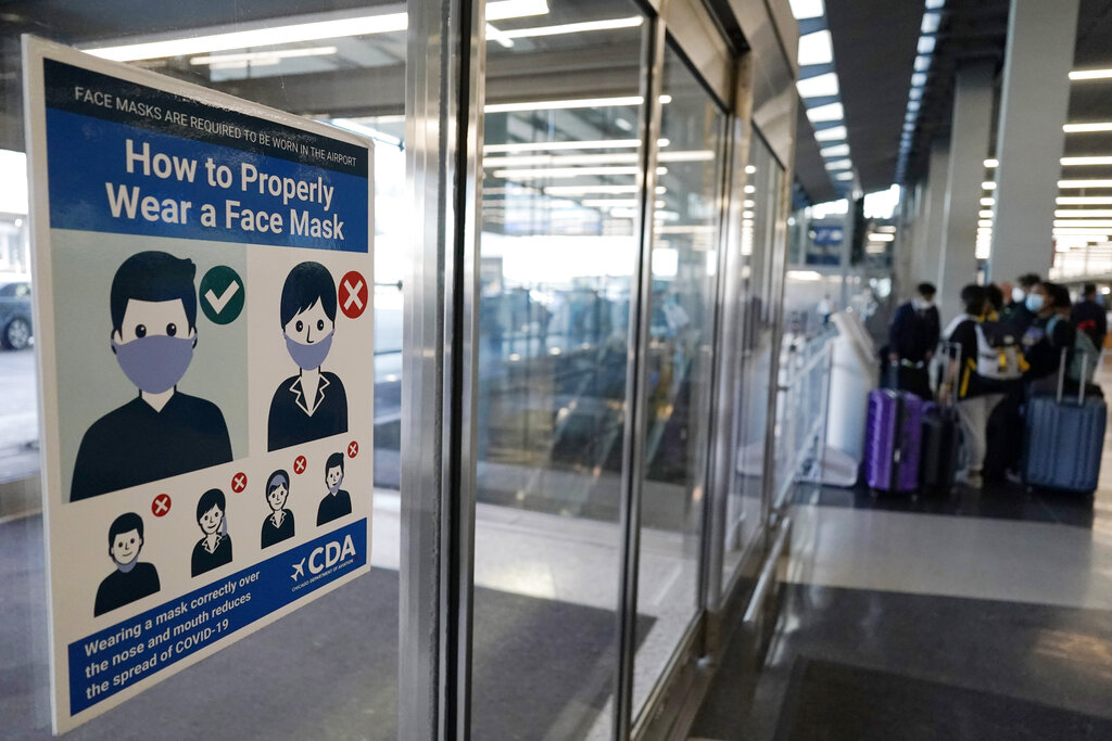 This July 2, 2021, file photo shows a sign stating face coverings are required is displayed at O'Hare airport in Chicago. (AP Photo/Nam Y. Huh, File)