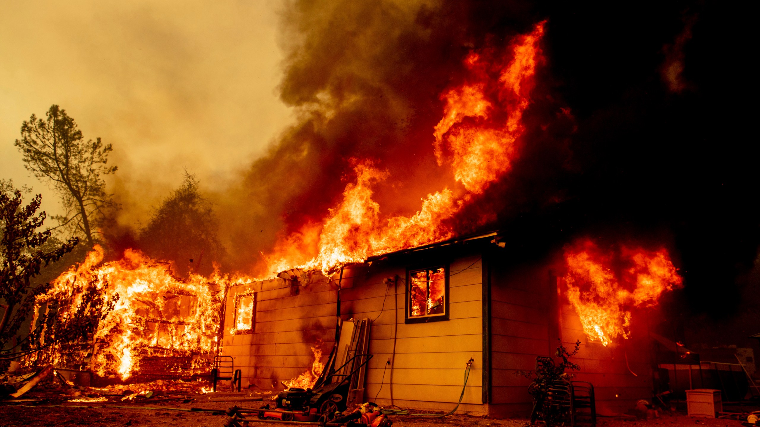 Flames consume a house near Old Oregon Trail as the Fawn Fire burns about 10 miles north of Redding in Shasta County, Calif., on Sep. 23, 2021. (Ethan Swope/Associated Press)