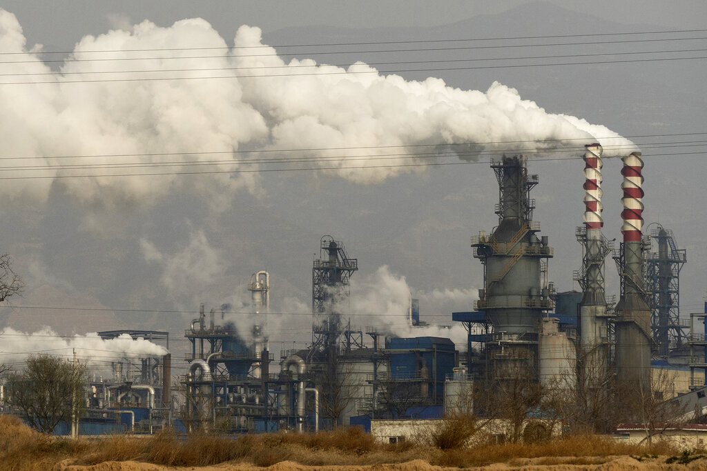 In this Nov. 28, 2019, file photo, smoke and steam rise from a coal processing plant in Hejin in central China's Shanxi Province. (AP Photo/Olivia Zhang, File)